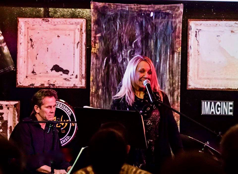 Two musicians perform on stage